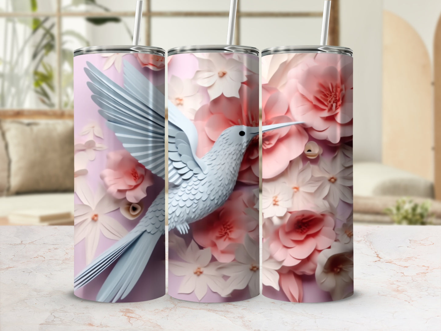 White hummingbird among pink and white floral patterns on a tumbler.