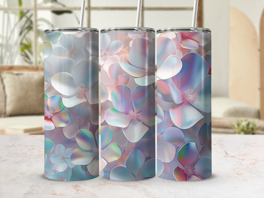 Three iridescent floral tumblers with straws on a marble countertop.