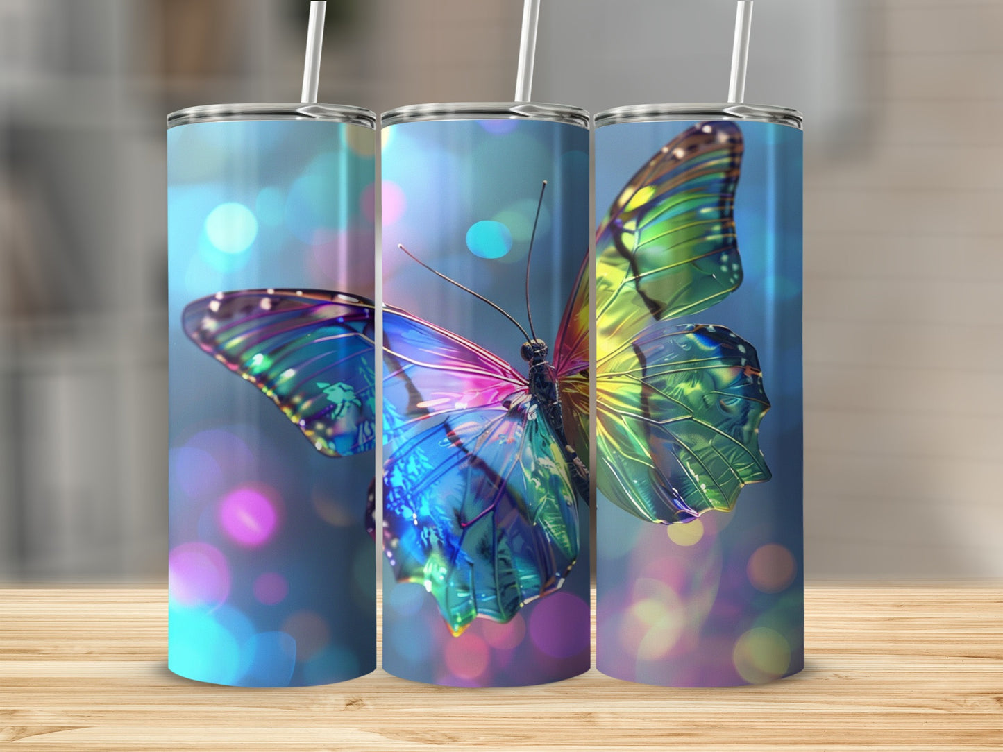 Three skinny tumblers with iridescent butterfly designs on blurred bokeh background.