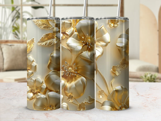 Gold floral embossed tumblers with straws against a blurred background.