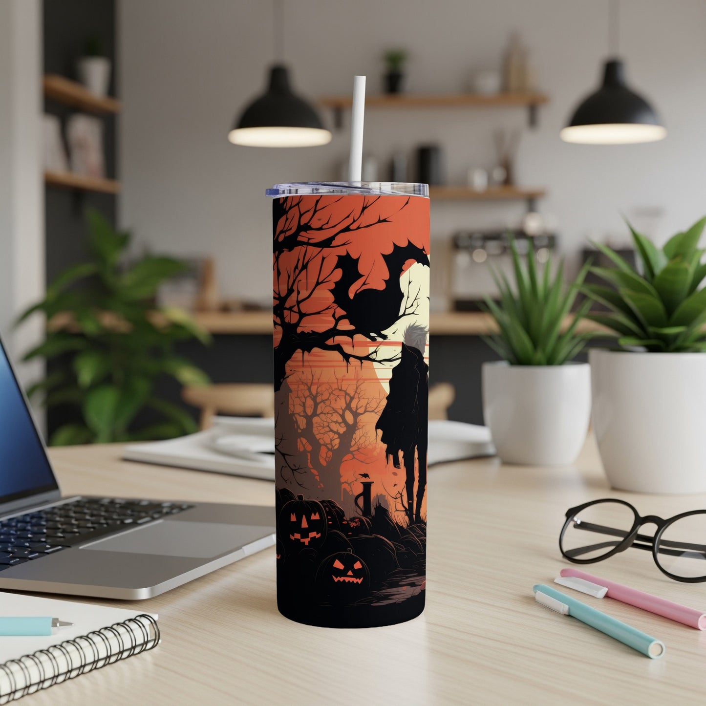 Halloween tumbler with silhouette of figure, bats, and carved pumpkins.