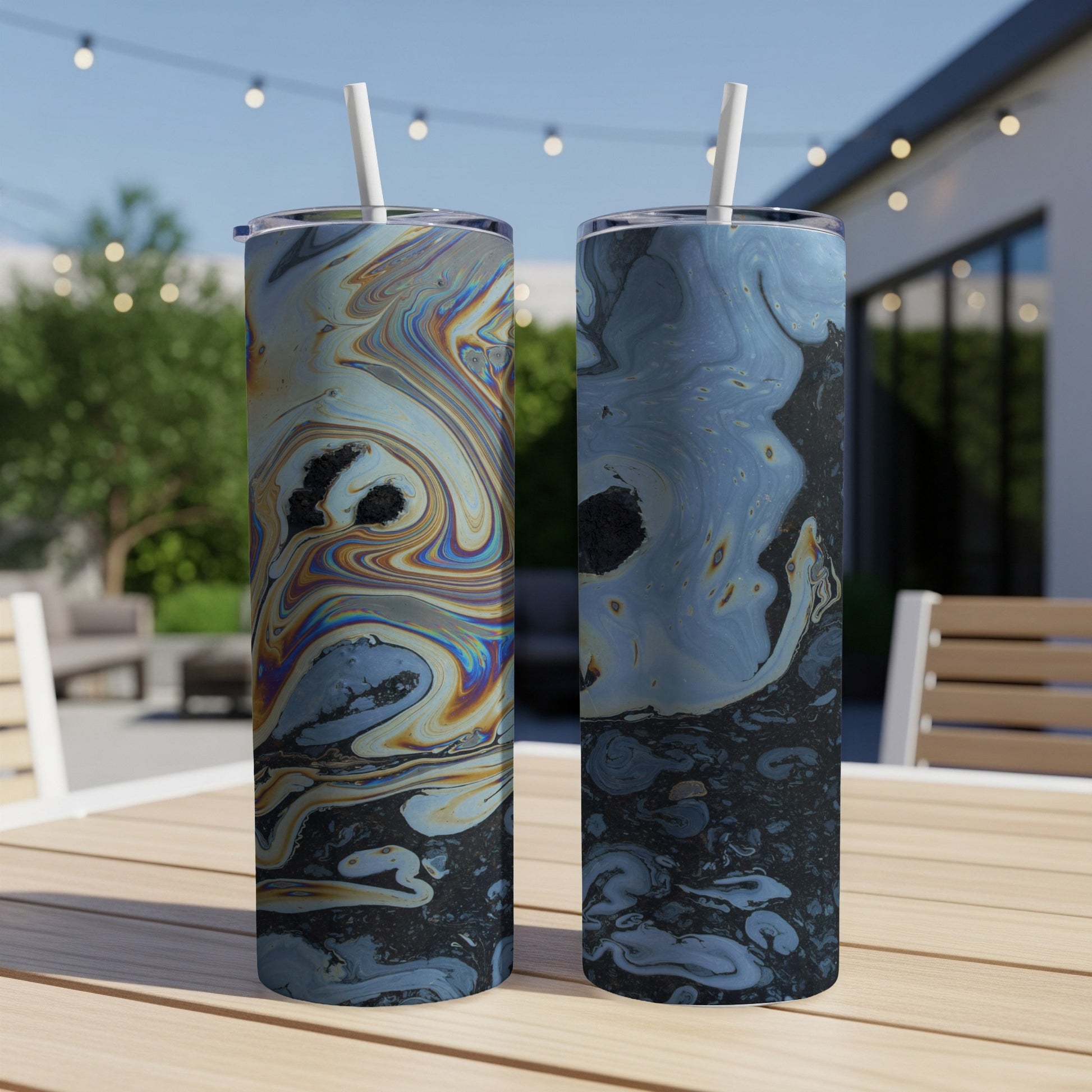 Two tumblers with colorful, marbled abstract patterns on a table.