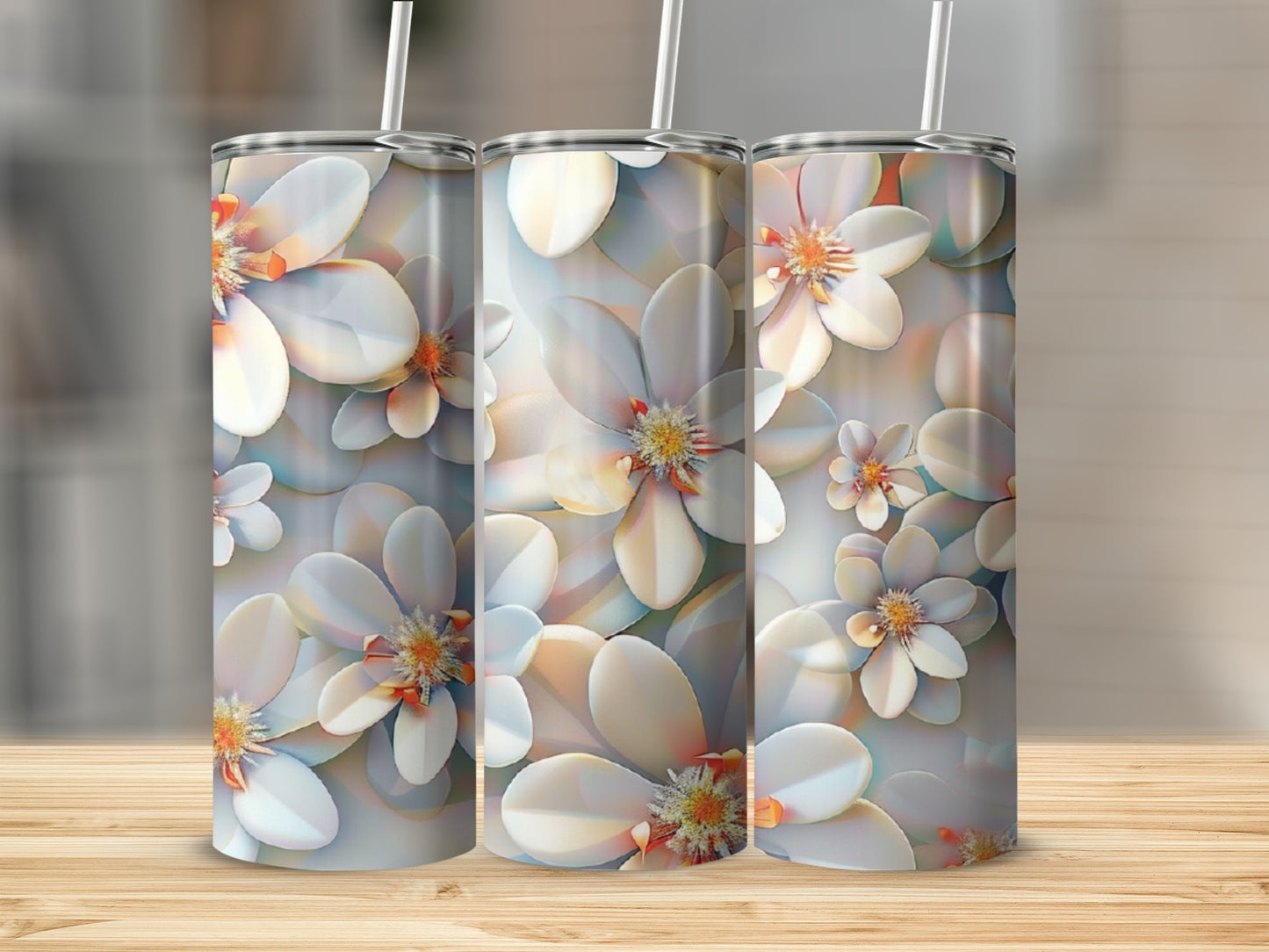 Three tumblers with white floral designs on a wooden surface.