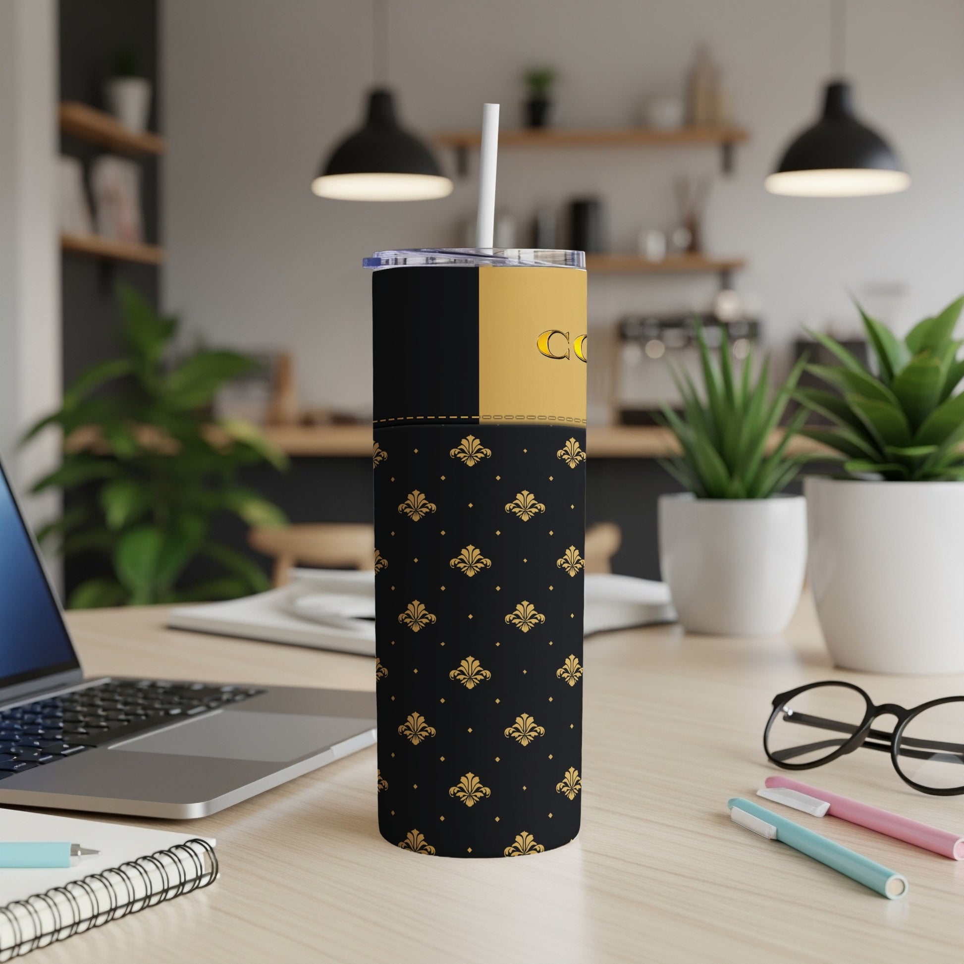 Black tumbler with gold fleur-de-lis pattern and gold text.