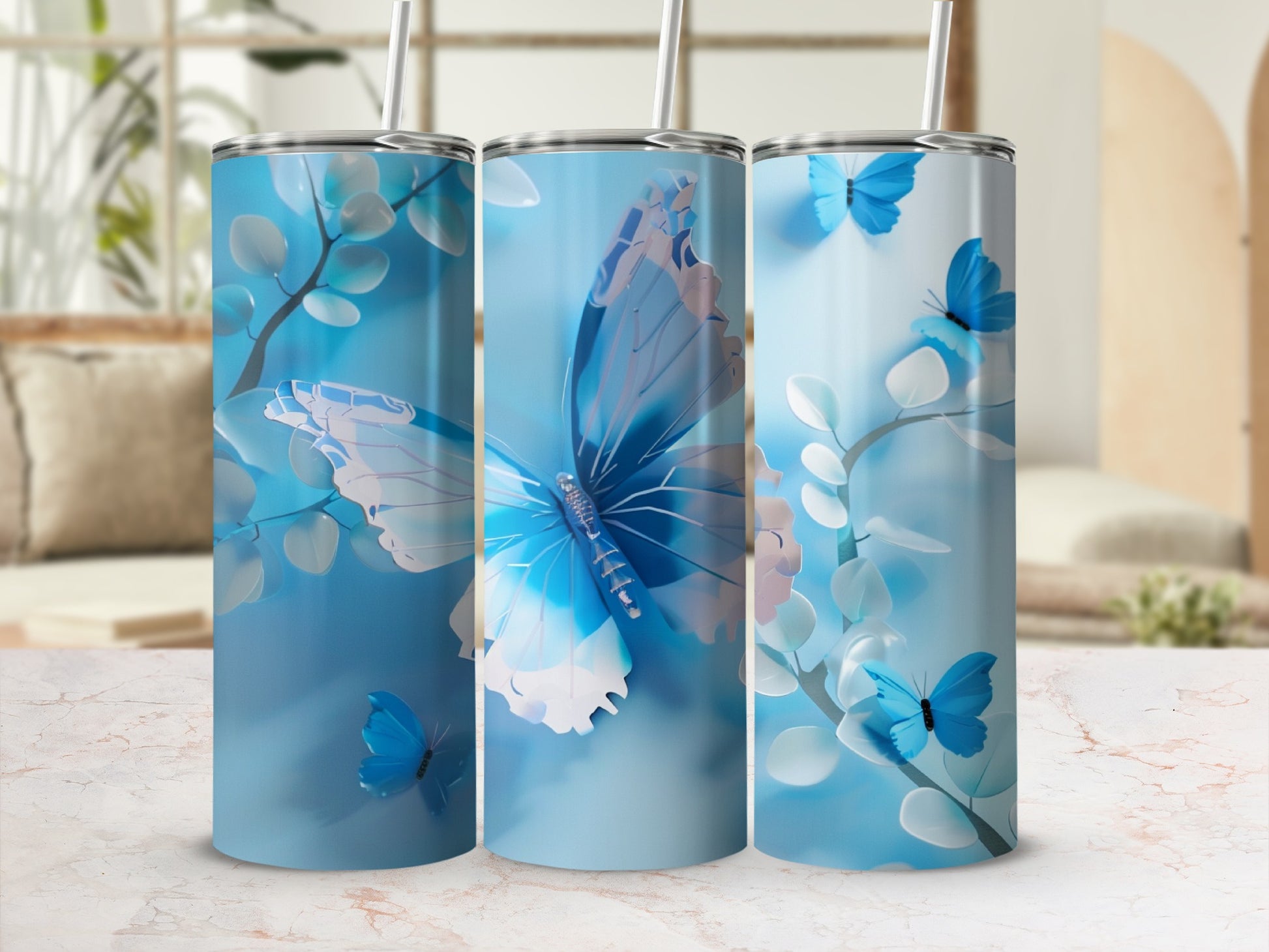 Three blue tumblers with butterfly and branch designs.