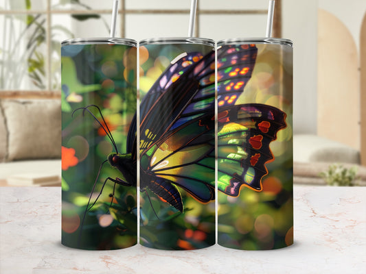 Butterfly tumbler with colorful wings against a bokeh background.