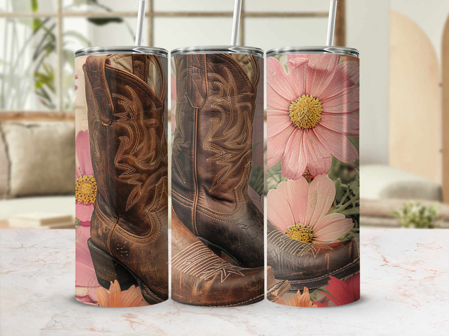Cowboy boots and pink flowers on a marble surface with straws.