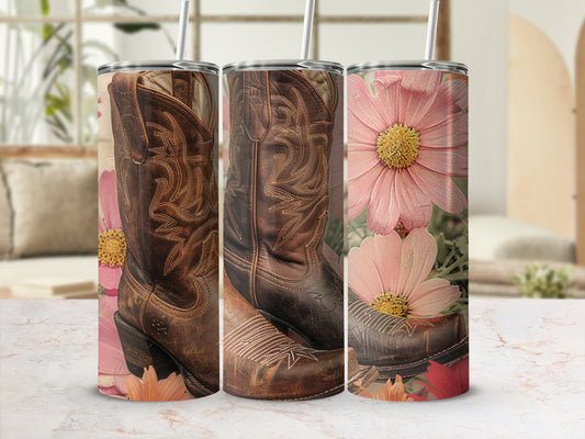 Cowboy boots and pink flowers on a marble surface with straws.