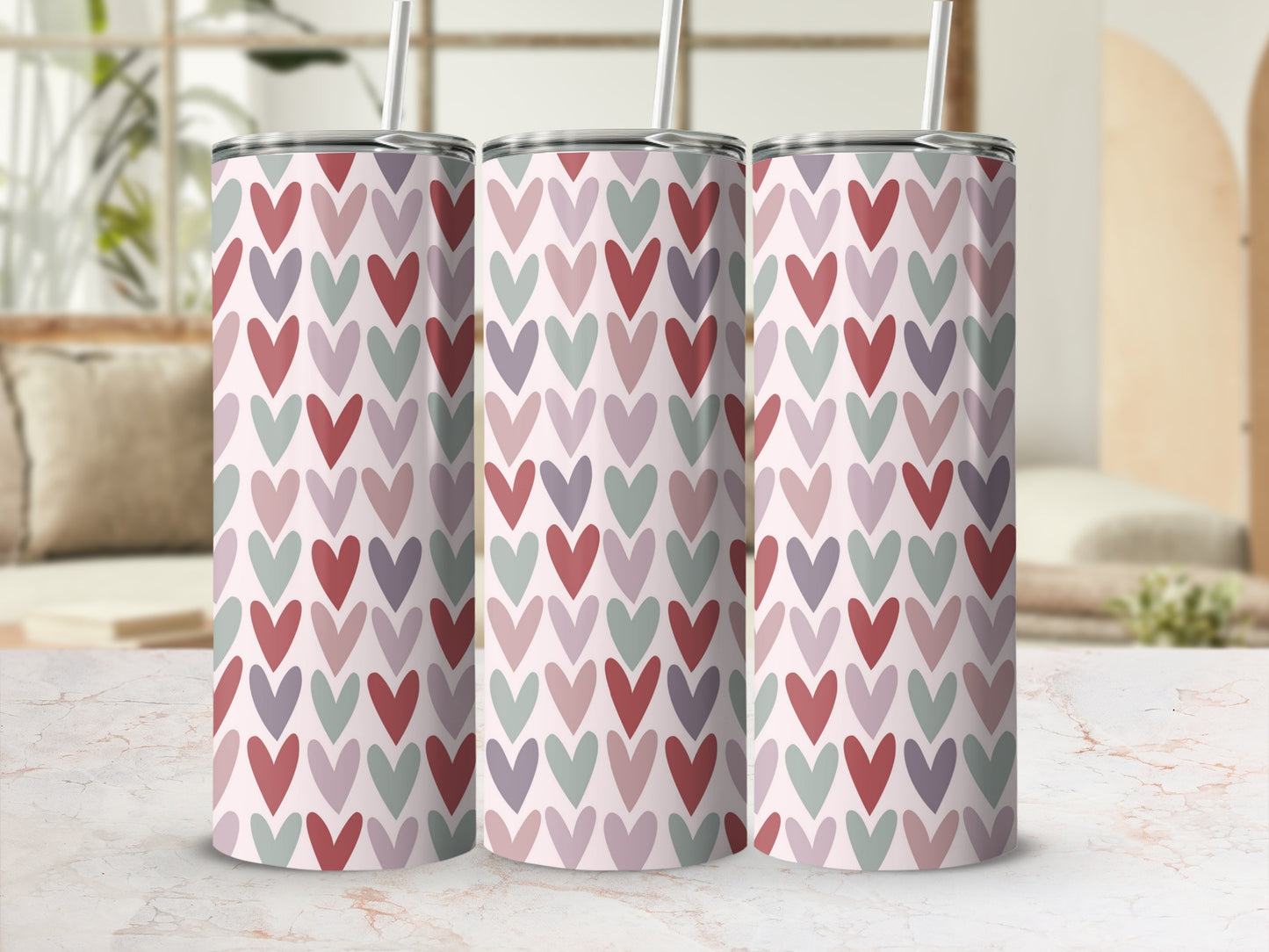 Three tall tumblers with a repeating pattern of small, muted hearts.