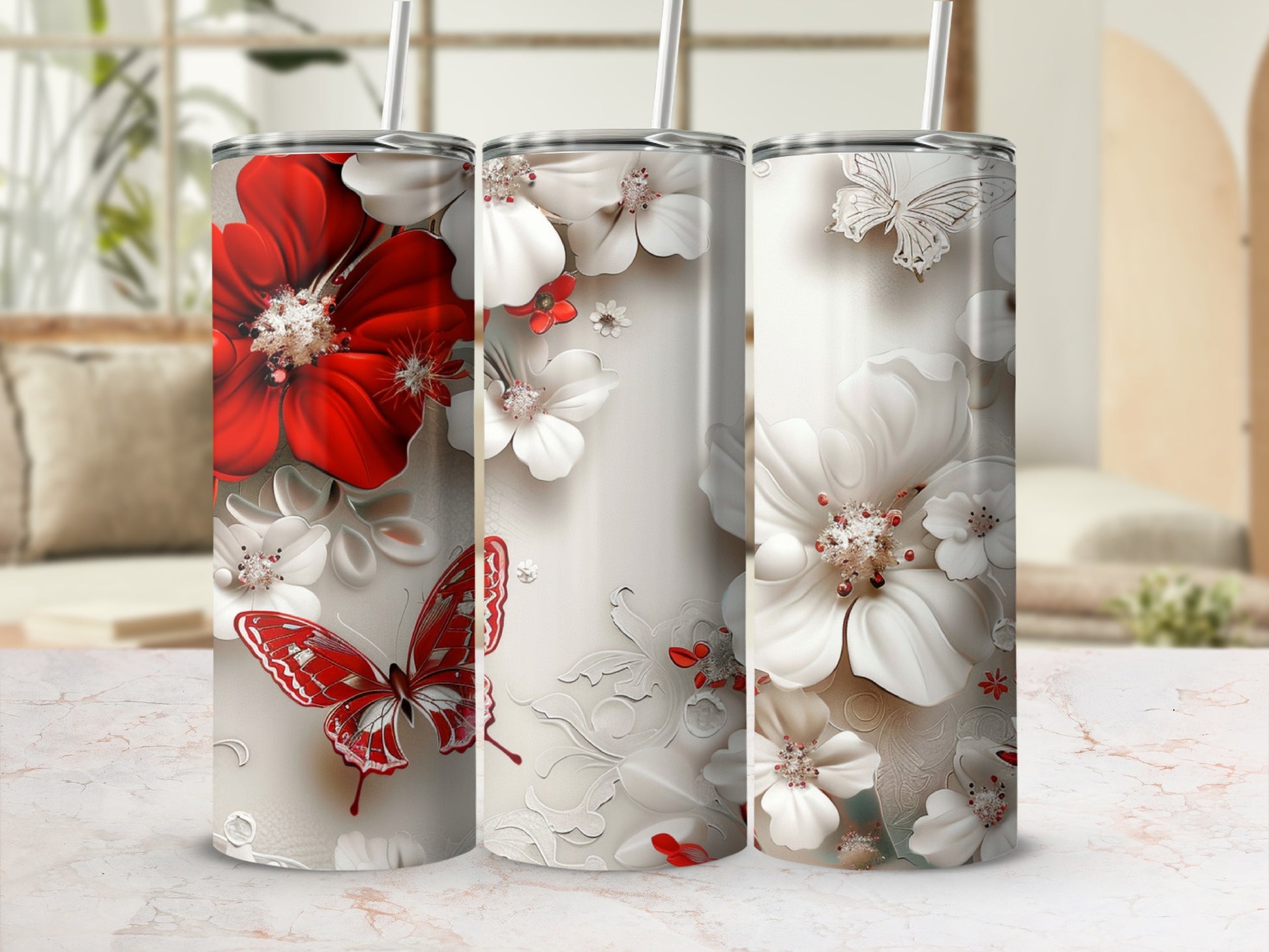 Three tumblers with red and white flowers and butterflies.