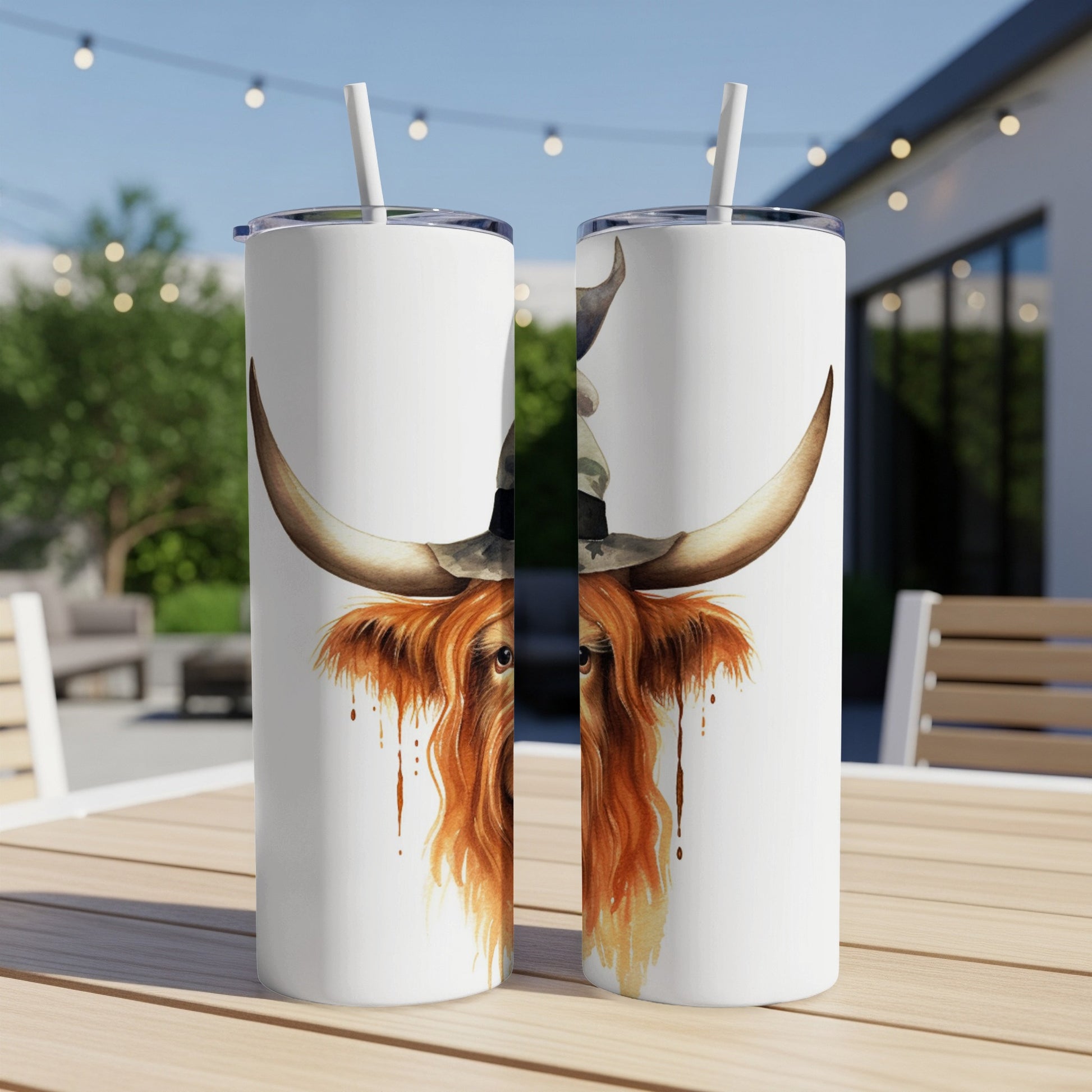 Two tumblers featuring a whimsical Highland cow with a witch hat.