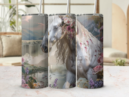 White horse with floral garland in a scenic waterfall landscape.