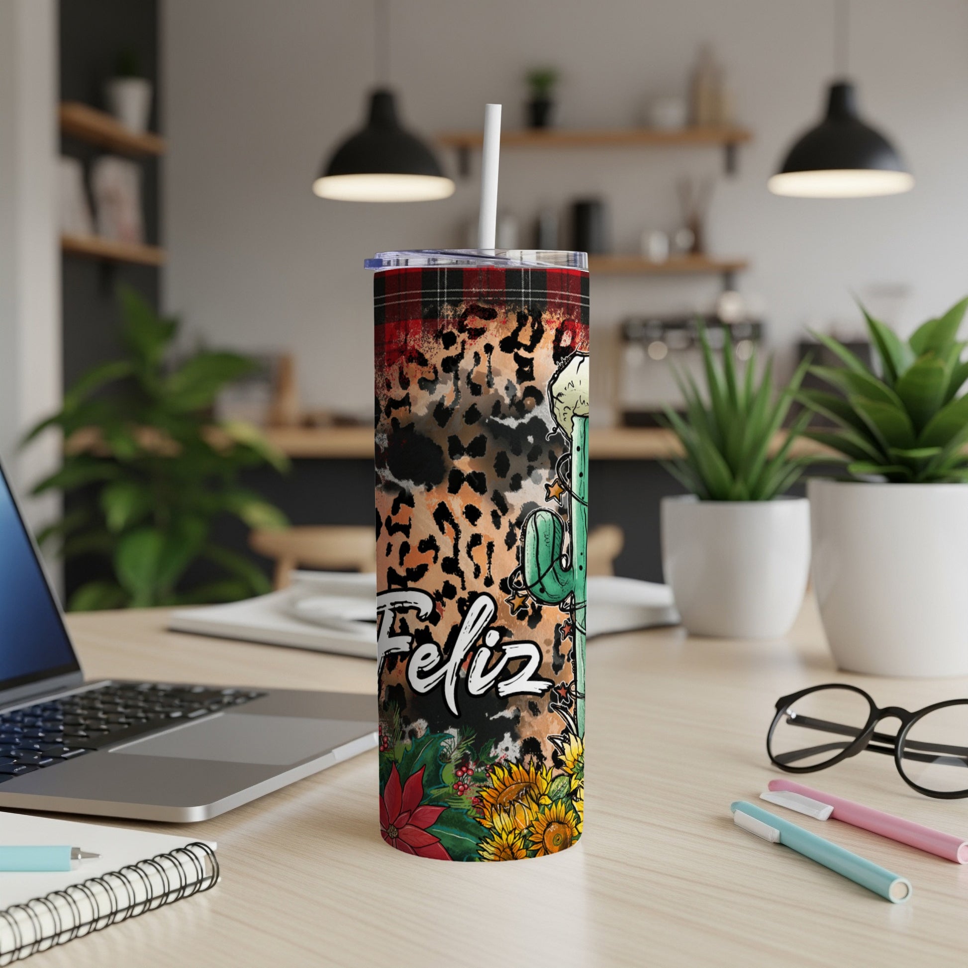 Tumbler with "Feliz" text and leopard, sunflower, and poinsettia designs.