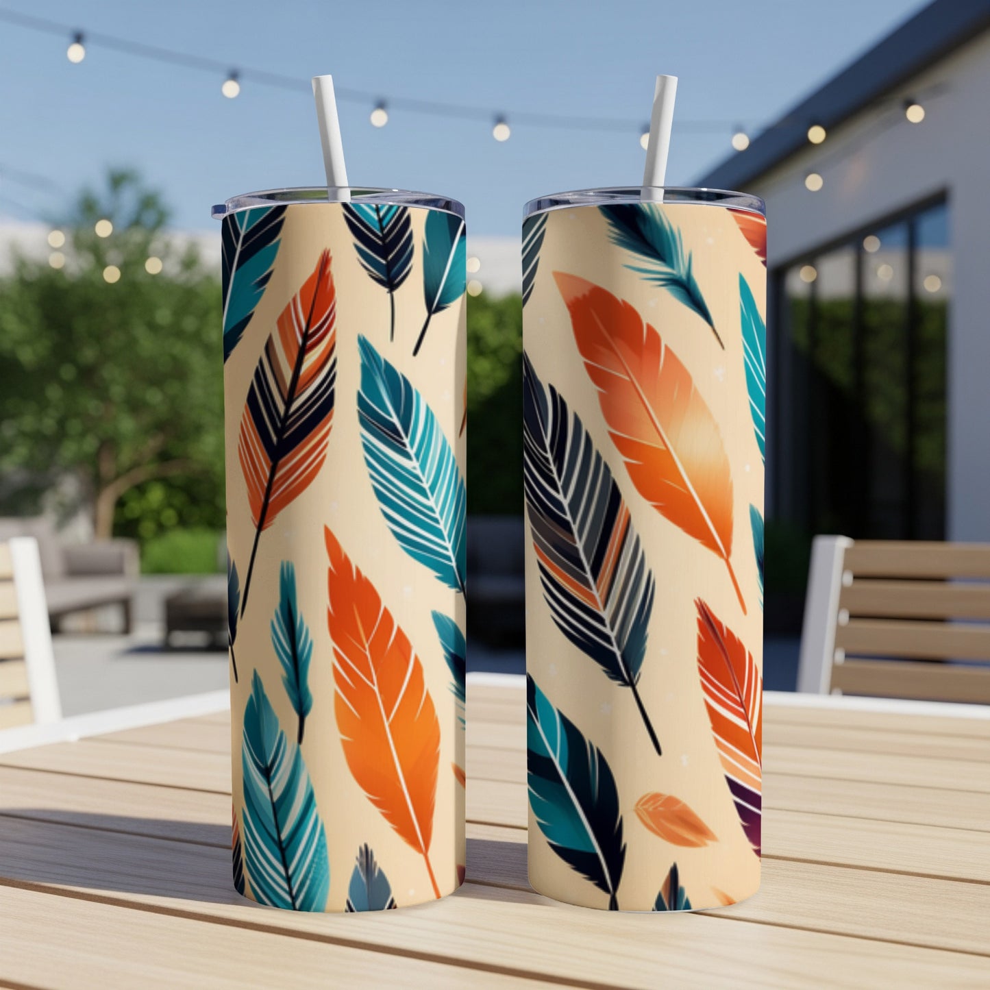 Two tumblers with a colorful feather pattern on a table.