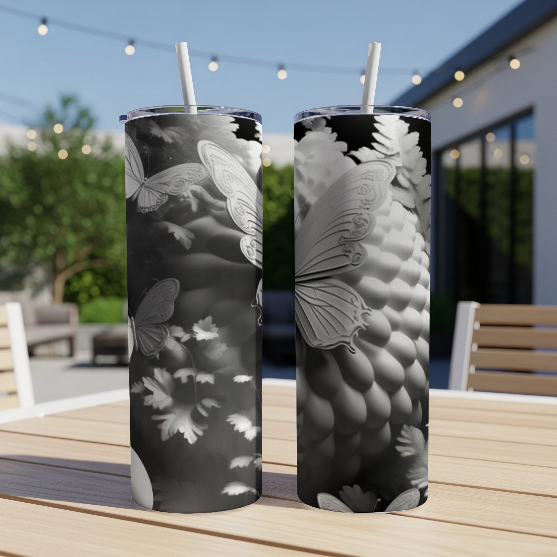 Two tumblers with white butterflies and floral motifs.