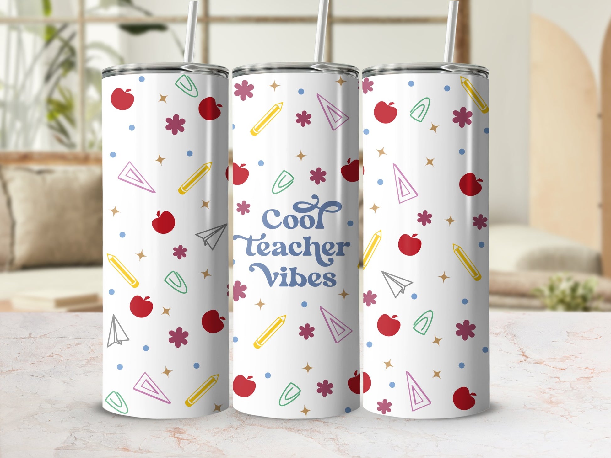 White tumbler with "Cool Teacher Vibes" text and scattered colorful apple, pencil, and star designs.