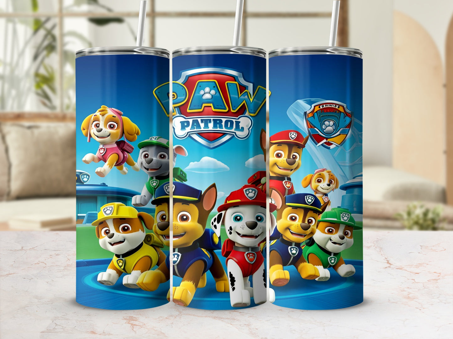 Paw Patrol characters on a blue tumbler with a white lid and straw.