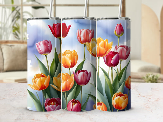Three tumblers with watercolor tulips on a light blue and white sky background.