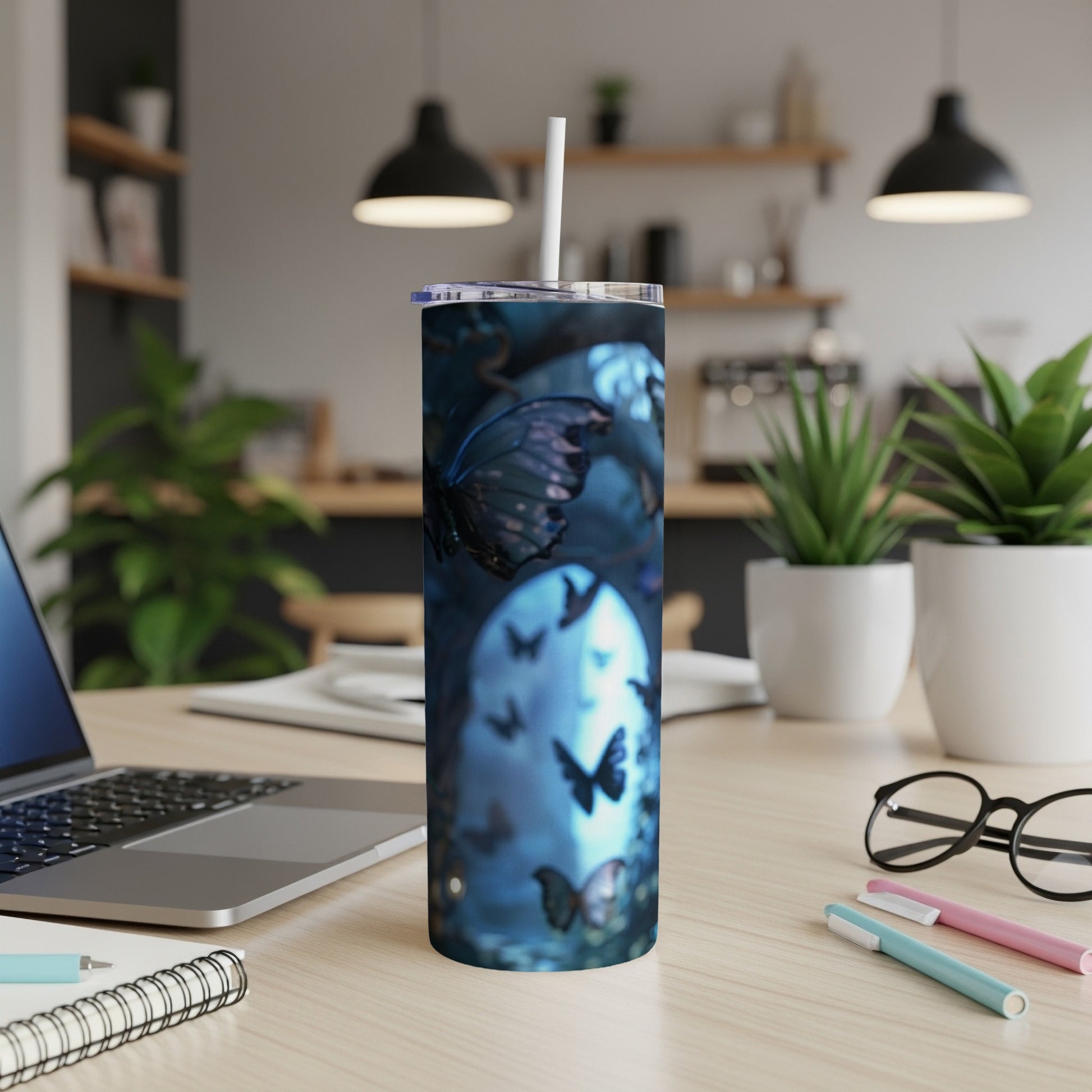 Blue tumbler with dark butterflies and moon design.