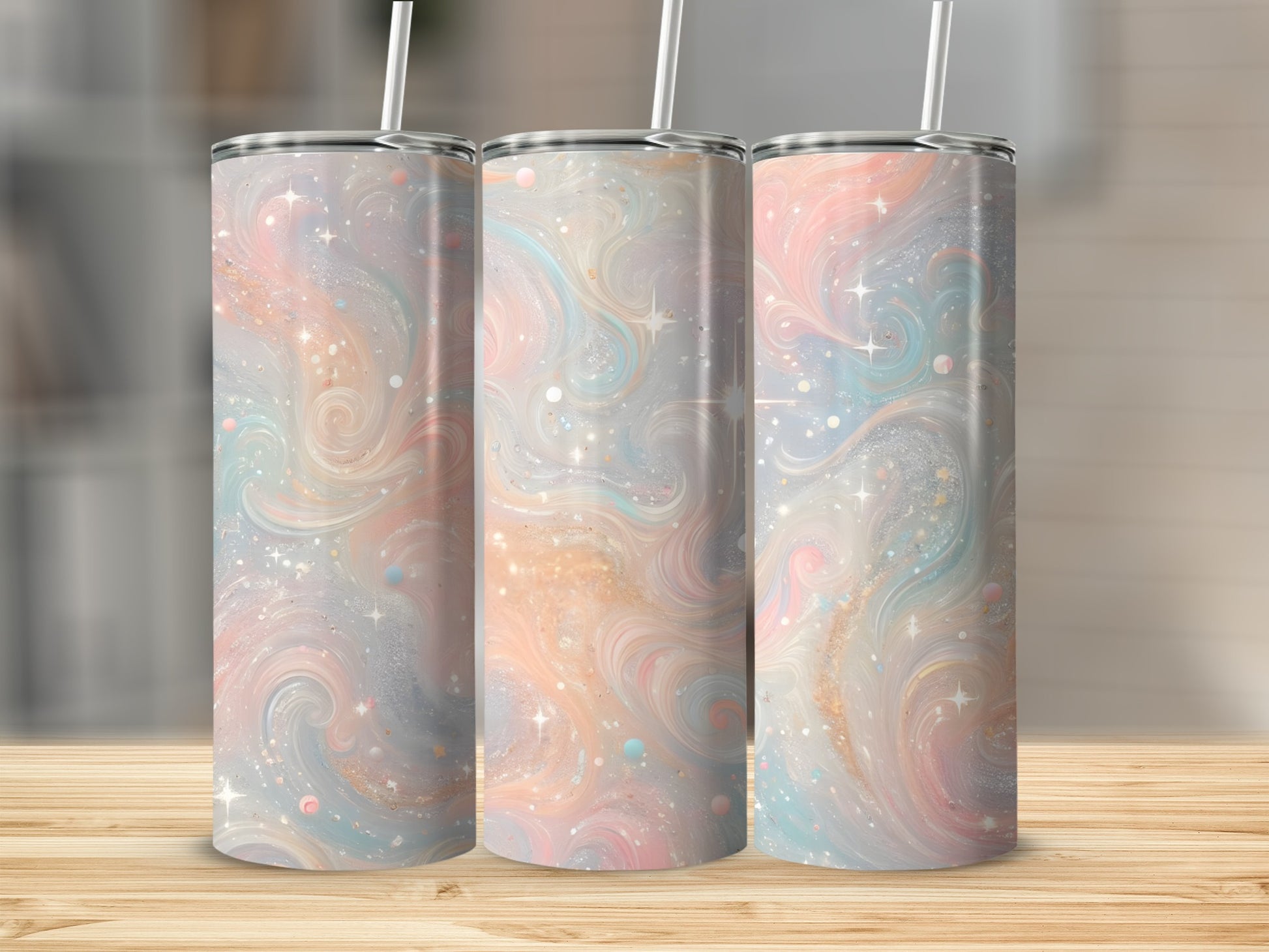 Three tumblers with pastel swirls and glitter pattern on a wooden surface.