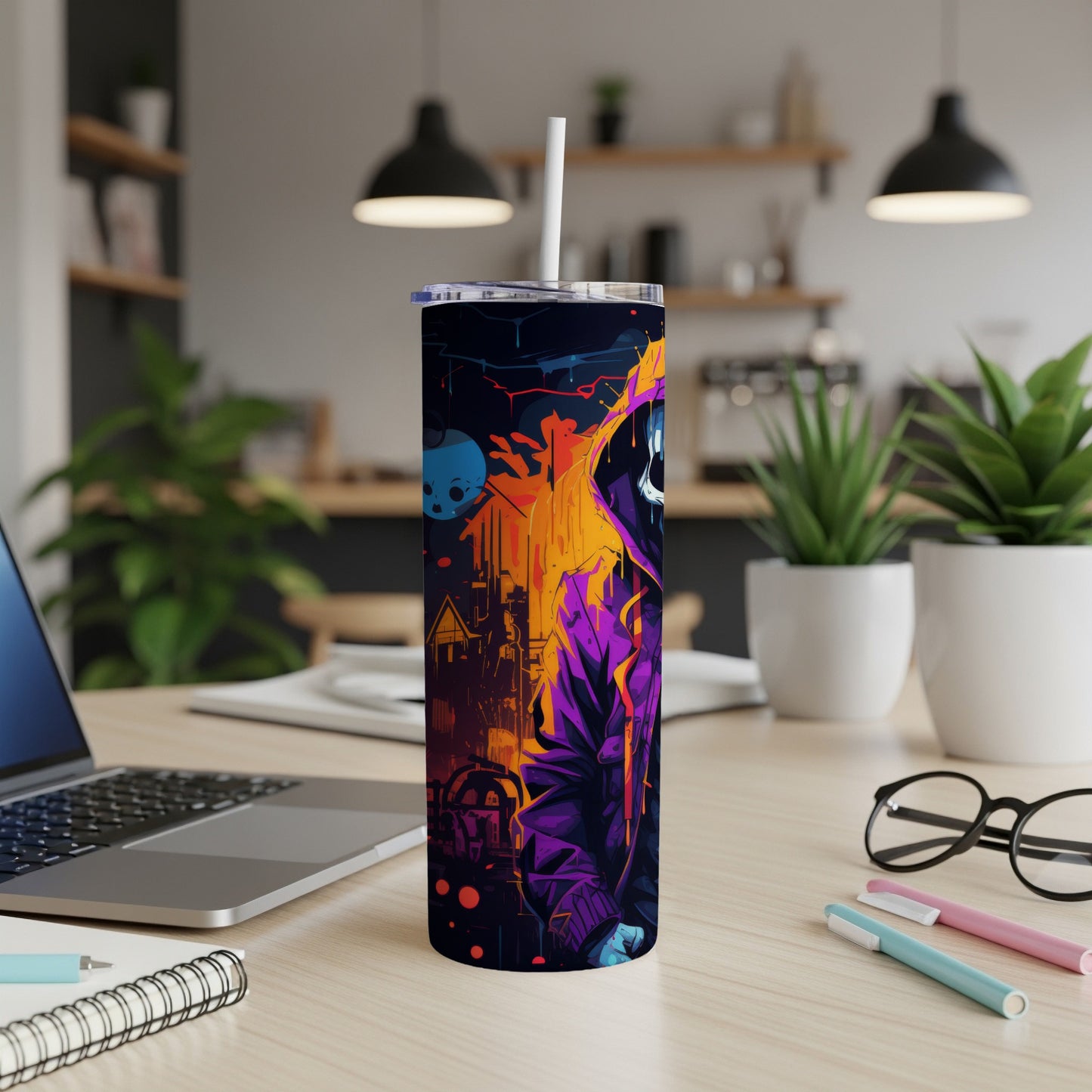 Tumbler with a hooded figure and cityscape design, with a straw.