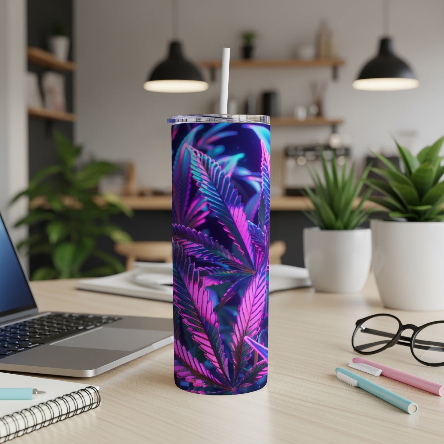 Purple and blue cannabis leaf design on a stainless steel tumbler with straw.