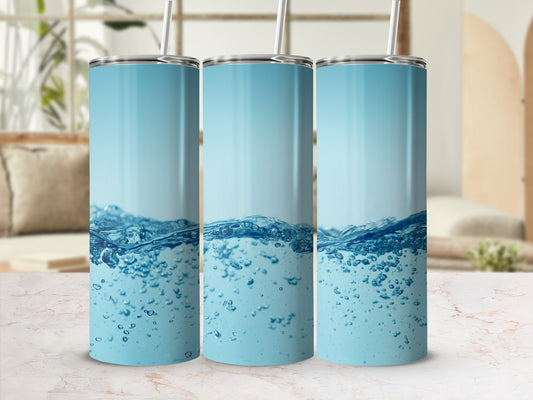 Three tumblers with blue water and bubble graphics on a marble surface.