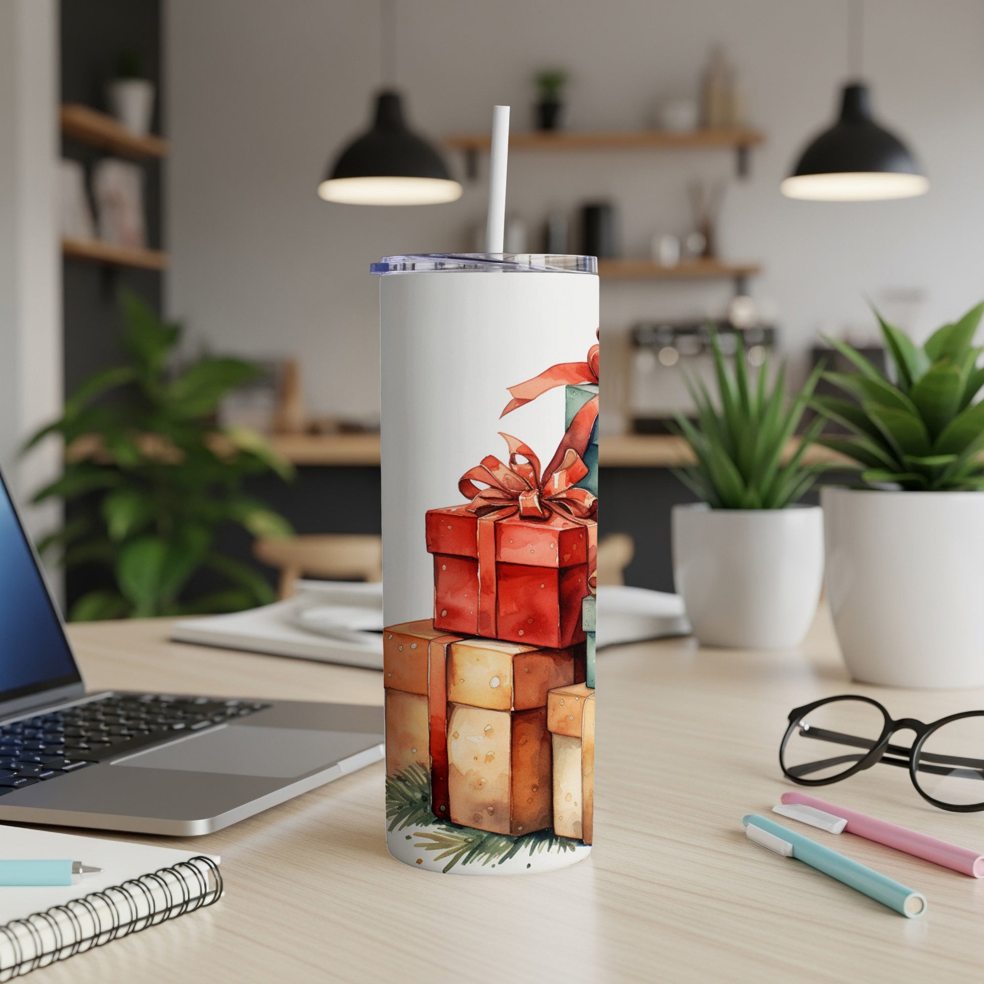 White tumbler with stacked Christmas gift boxes and pine sprigs.