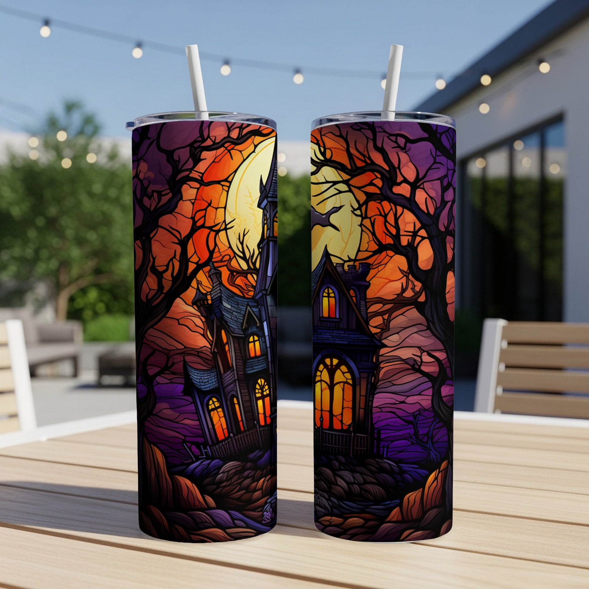 Halloween haunted house with moon and bare trees on tumblers.