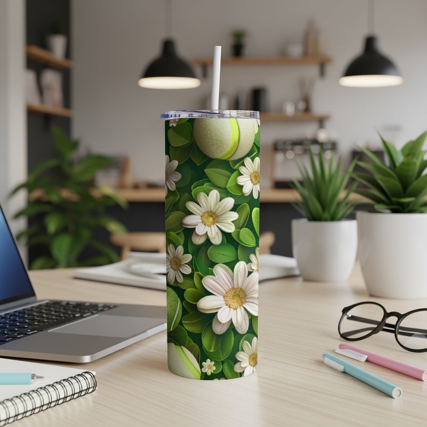 Green floral tumbler with white flowers and tennis balls.