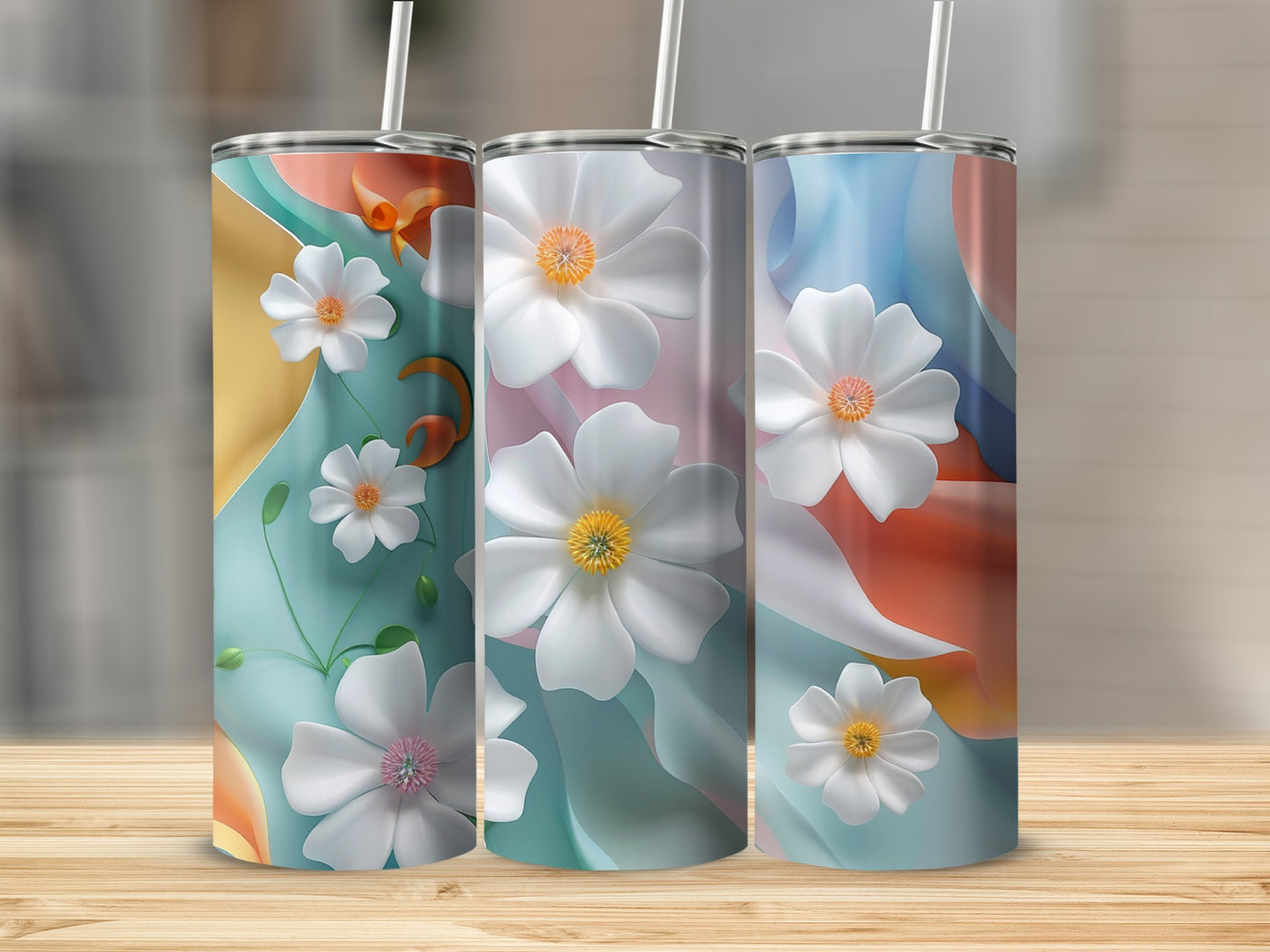 Three tumblers with abstract floral designs and pastel colors.