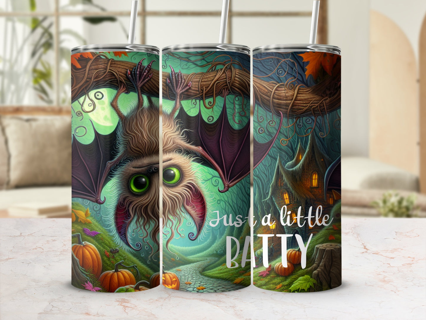 Three tumblers with a Halloween theme featuring a bat, pumpkins, and a spooky house.