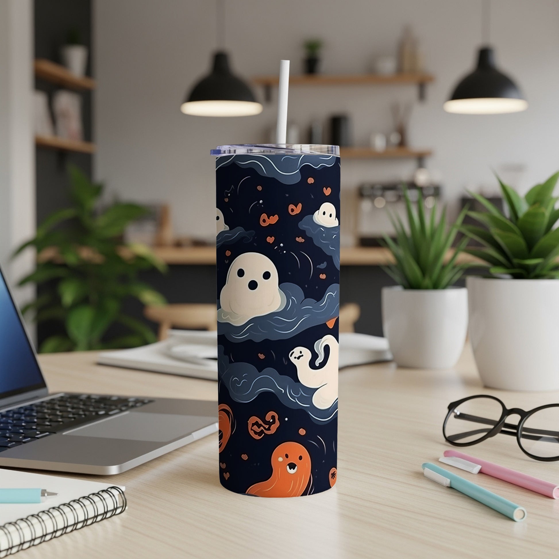 Tumbler with a dark blue background featuring cartoon ghosts and orange hearts.