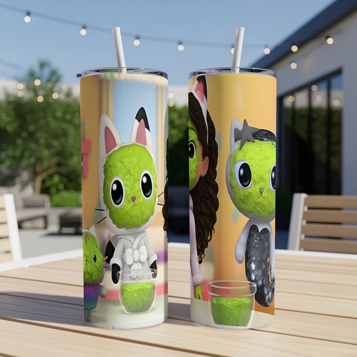 Two Gabby's Dollhouse themed tumblers with straws on a table.