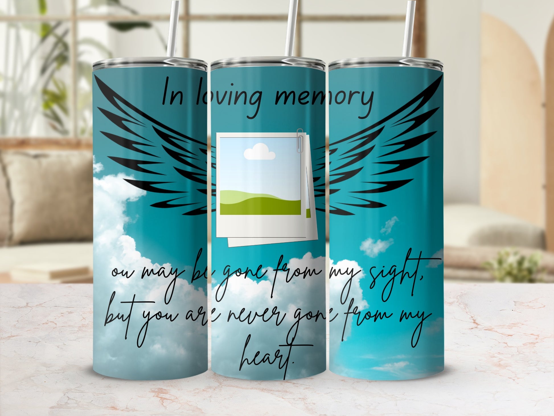 Tumbler with angel wings, clouds, and memorial text.