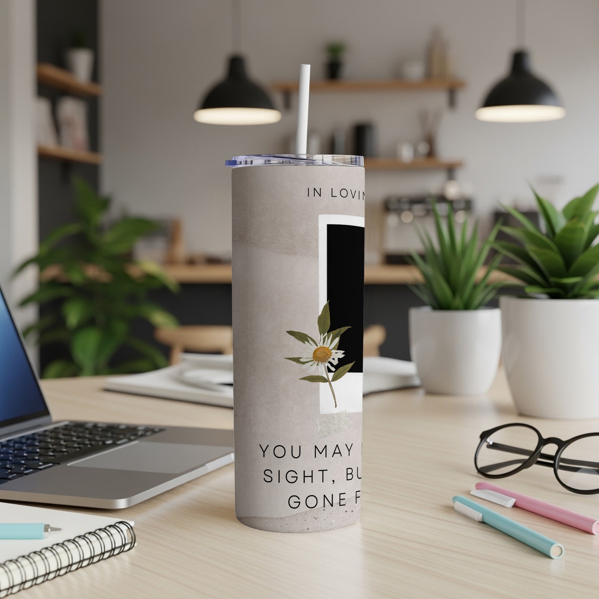 Memorial tumbler with text "In loving memory" and floral design.