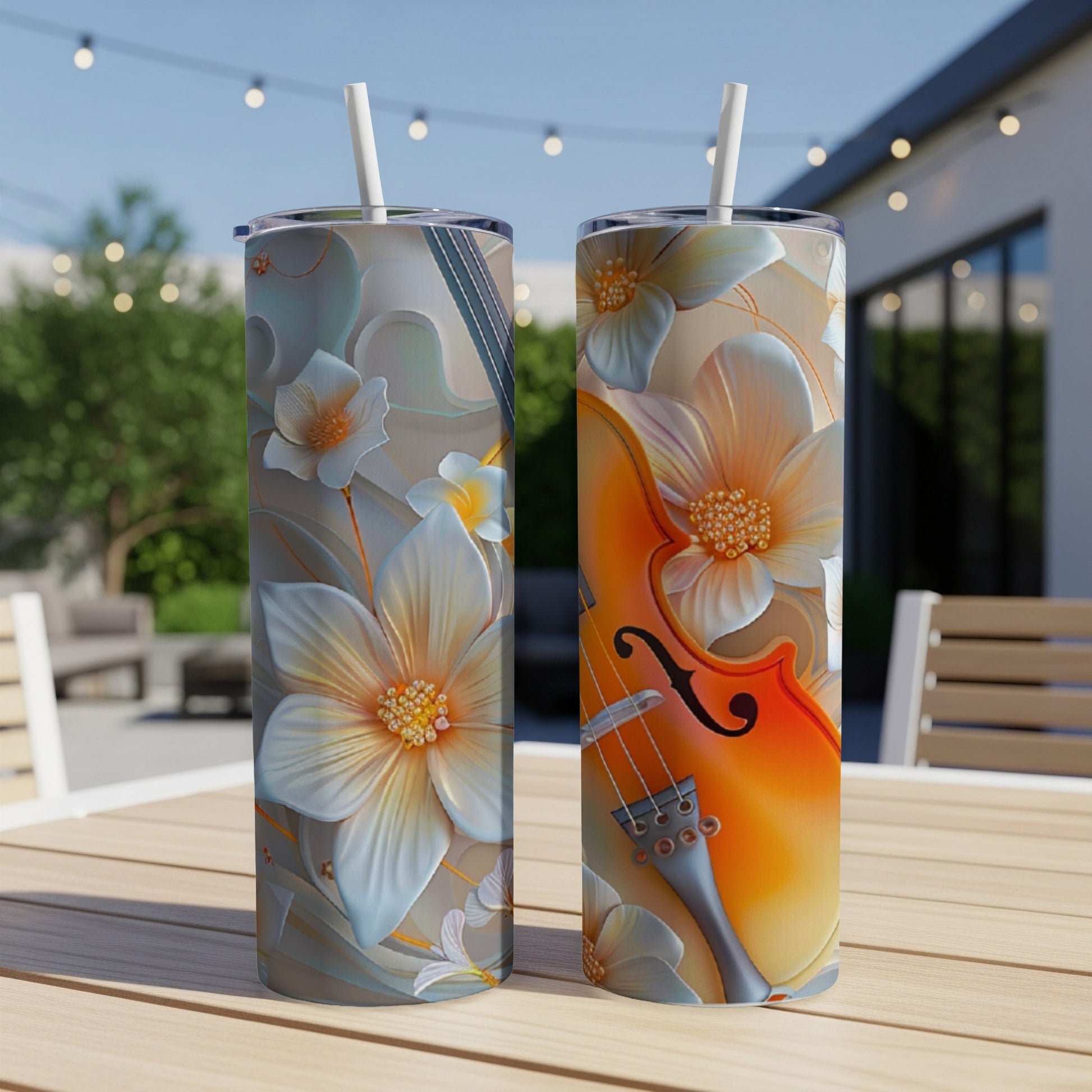 Two tall tumblers with a floral and violin design on a wooden table.