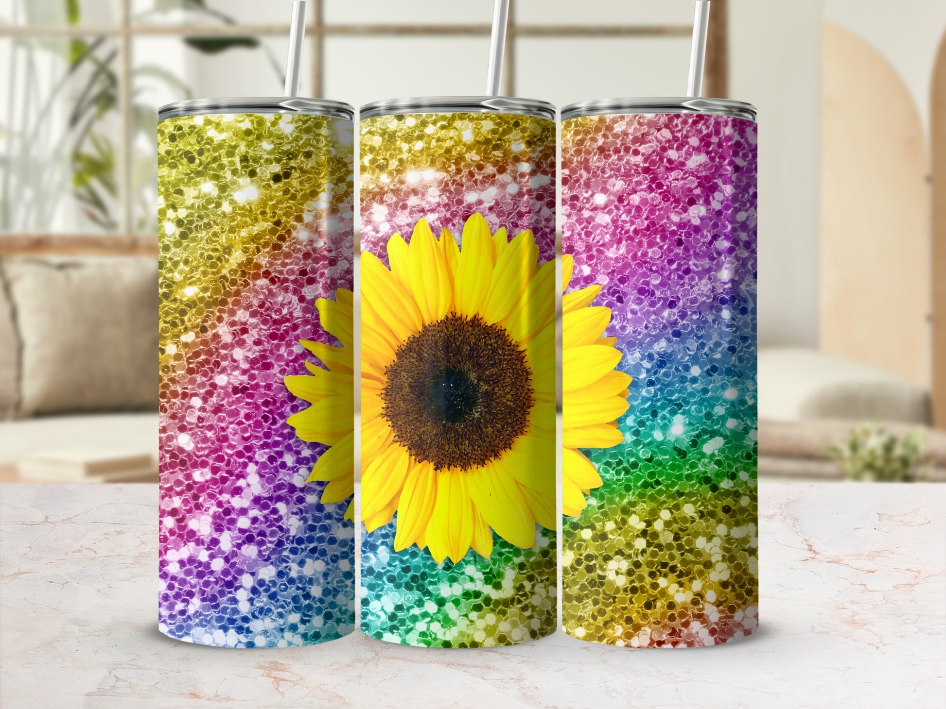 Three glitter tumblers with sunflower and rainbow ombre patterns.