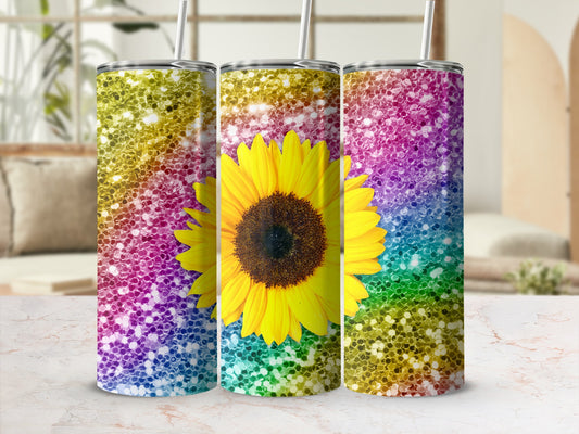 Three glitter tumblers with sunflower and rainbow ombre patterns.