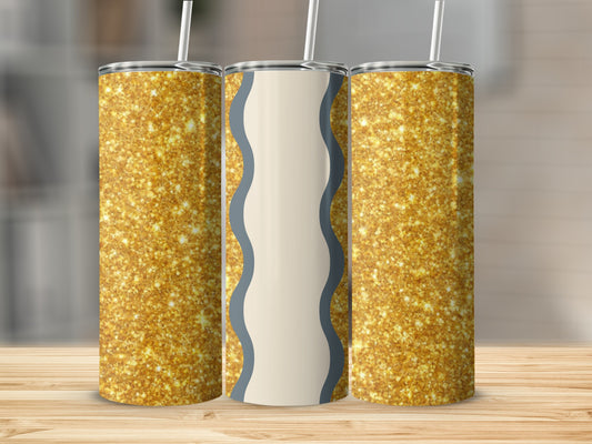 Three glittery gold tumblers with straws on a wooden surface.