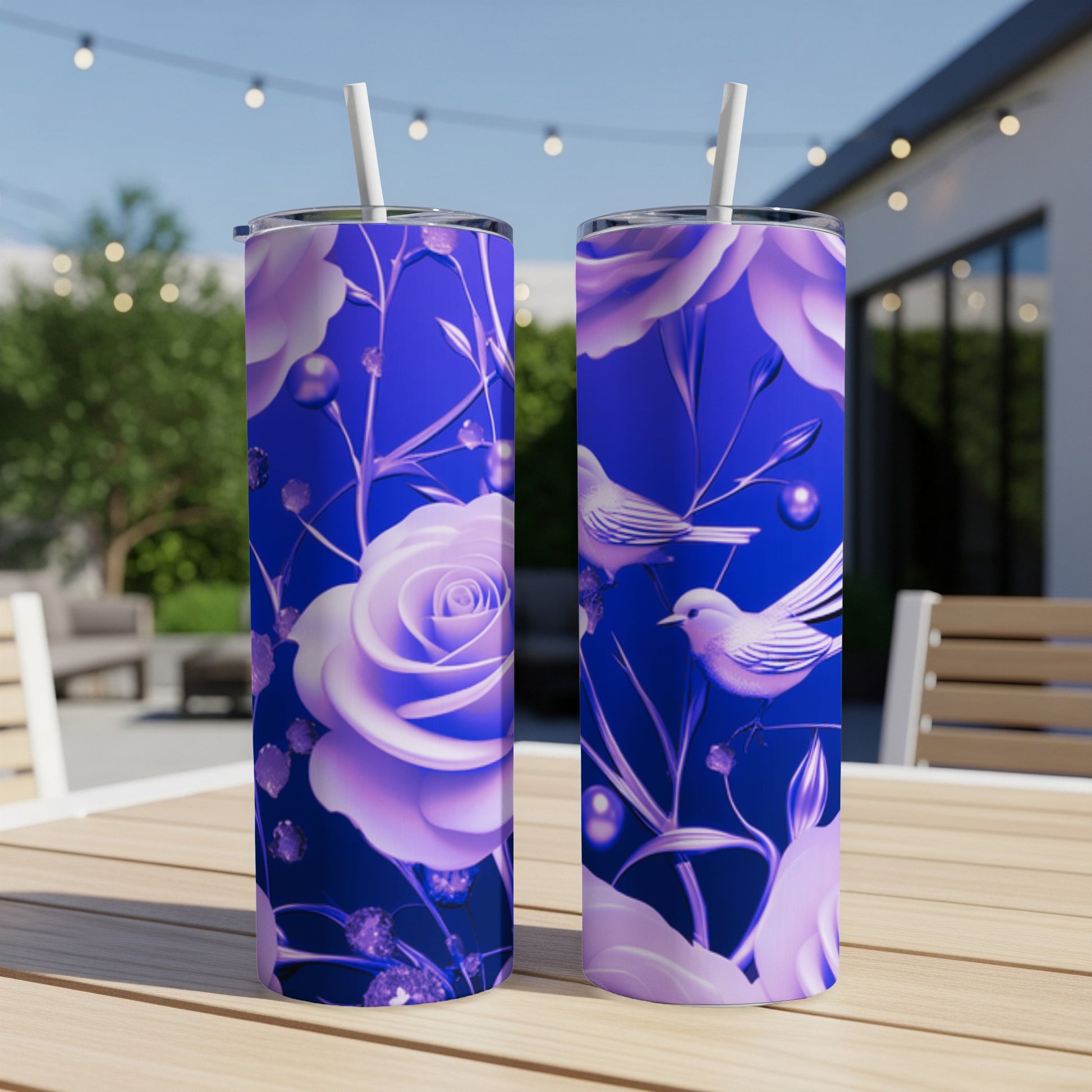 Two purple floral tumblers with birds on a wooden table.