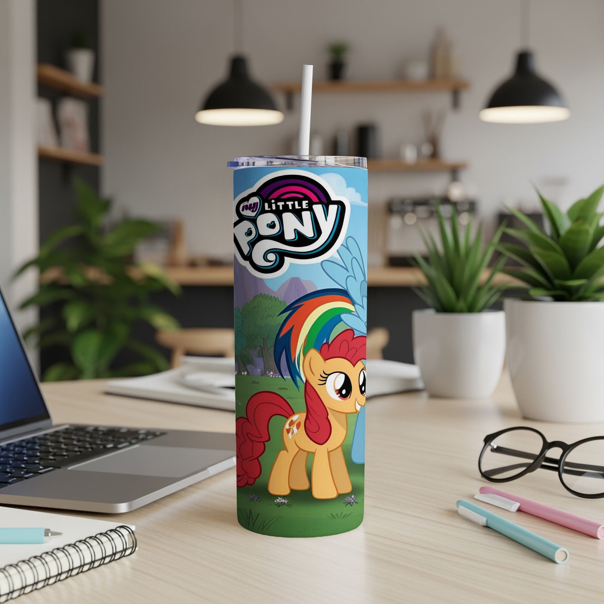My Little Pony Rainbow Dash tumbler with straw on a desk.