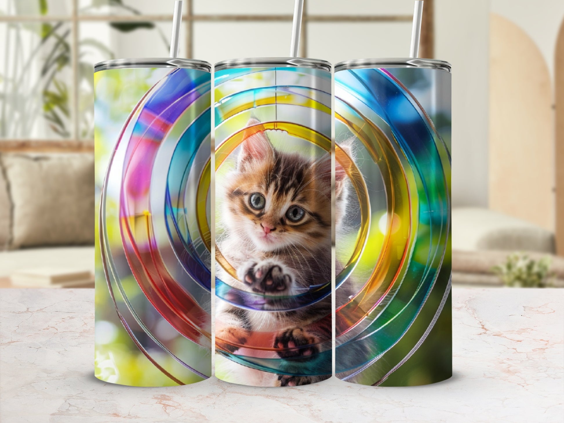 Kitten peeking through colorful concentric circles on a tumbler.