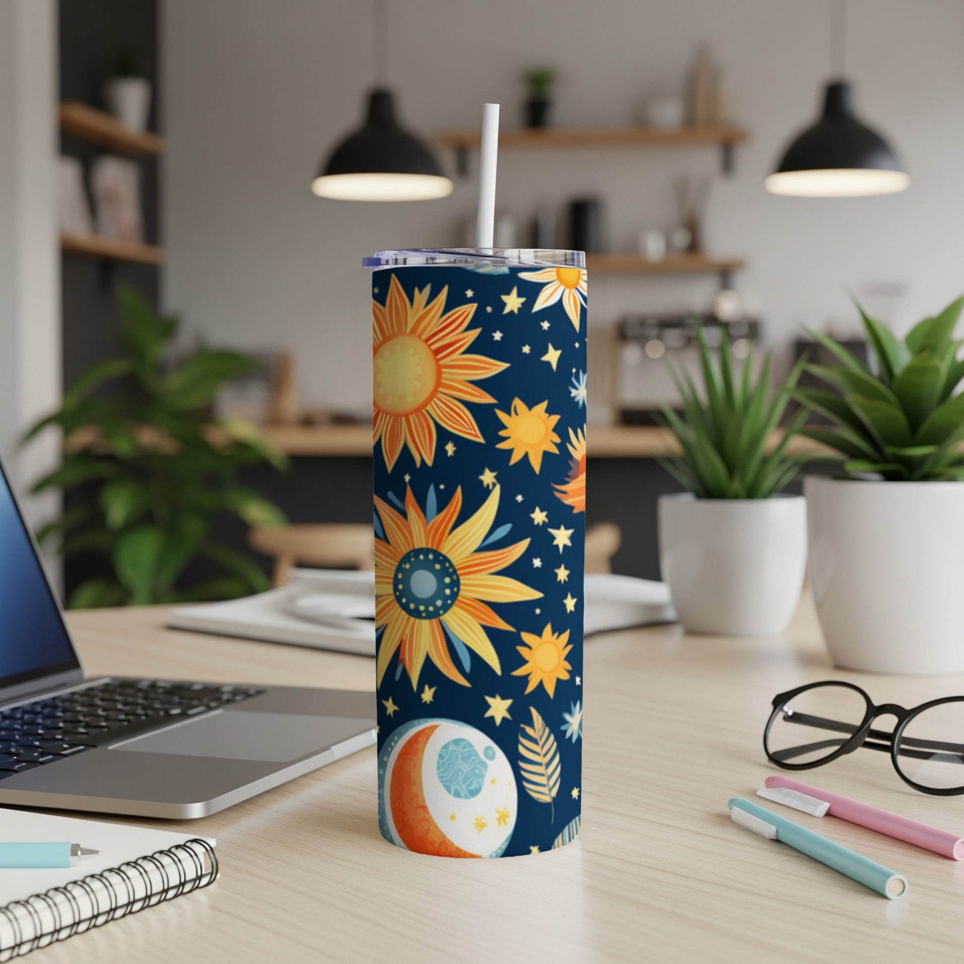 Tall skinny tumbler with celestial sun, moon, and star pattern.