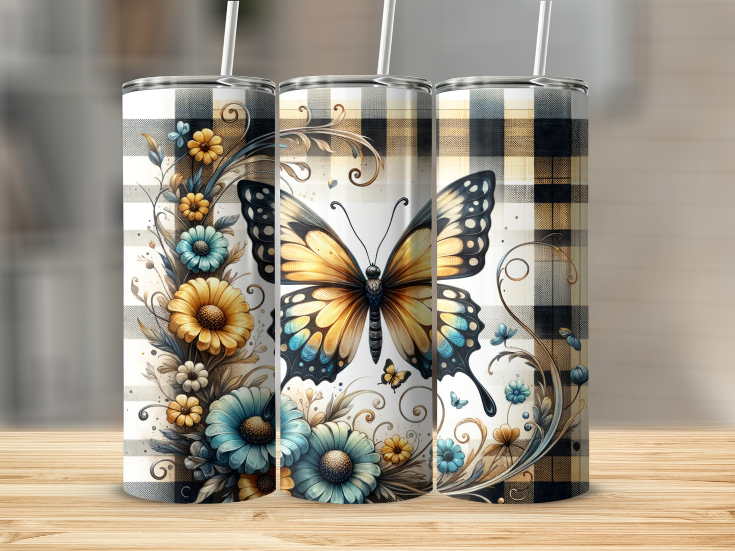 Three tumblers featuring a monarch butterfly and floral design on a plaid background.