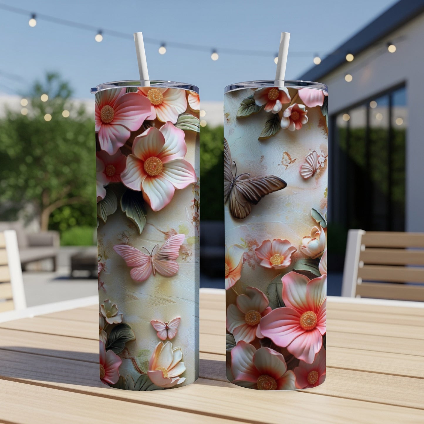 Two tumblers with floral and butterfly relief design on a wooden table.