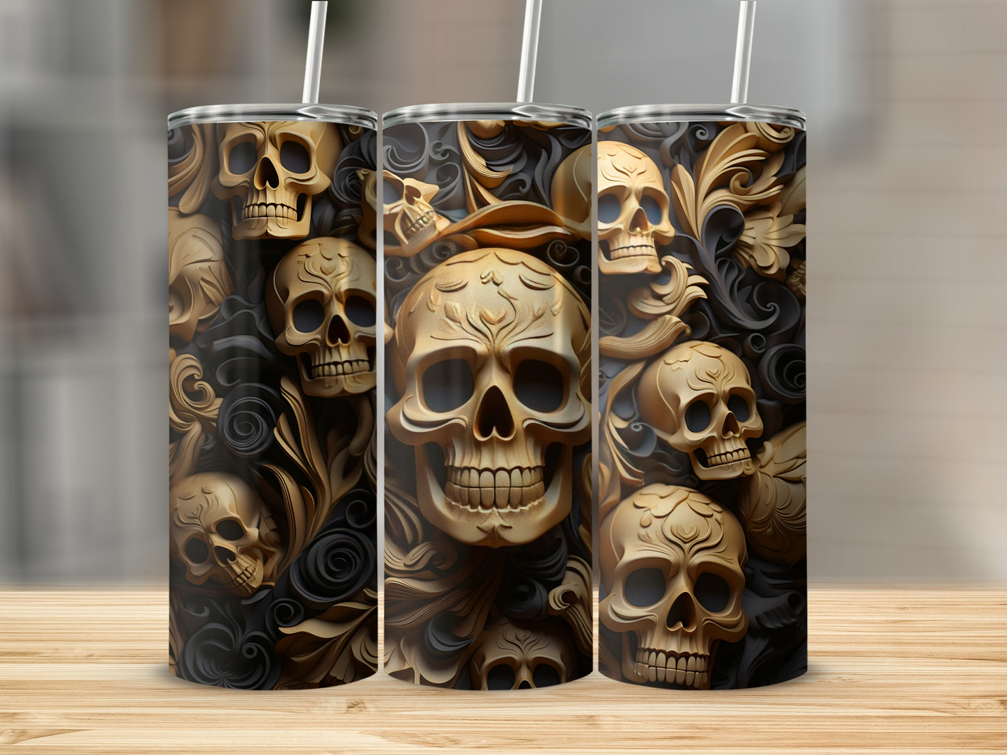 Gold skulls and ornate scrollwork pattern on three tumblers.