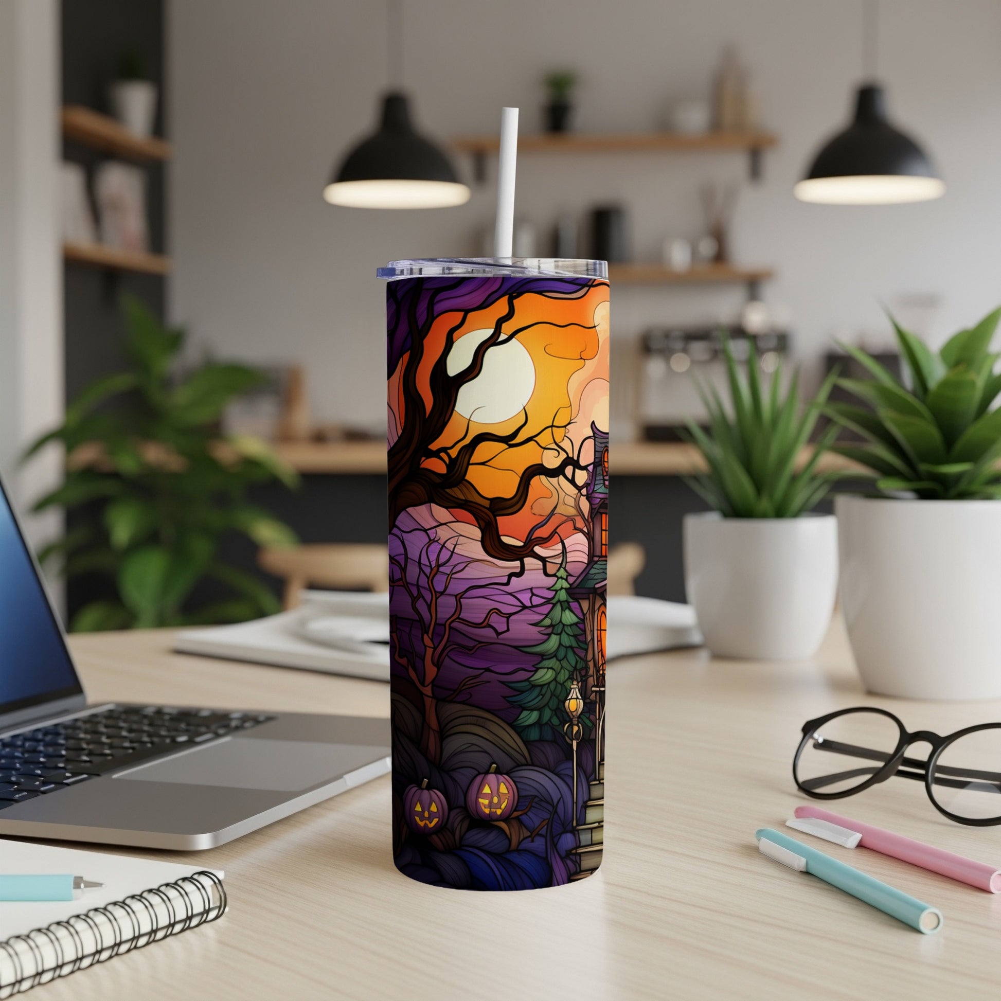 Halloween tumbler with spooky house, pumpkin lanterns, and a full moon.