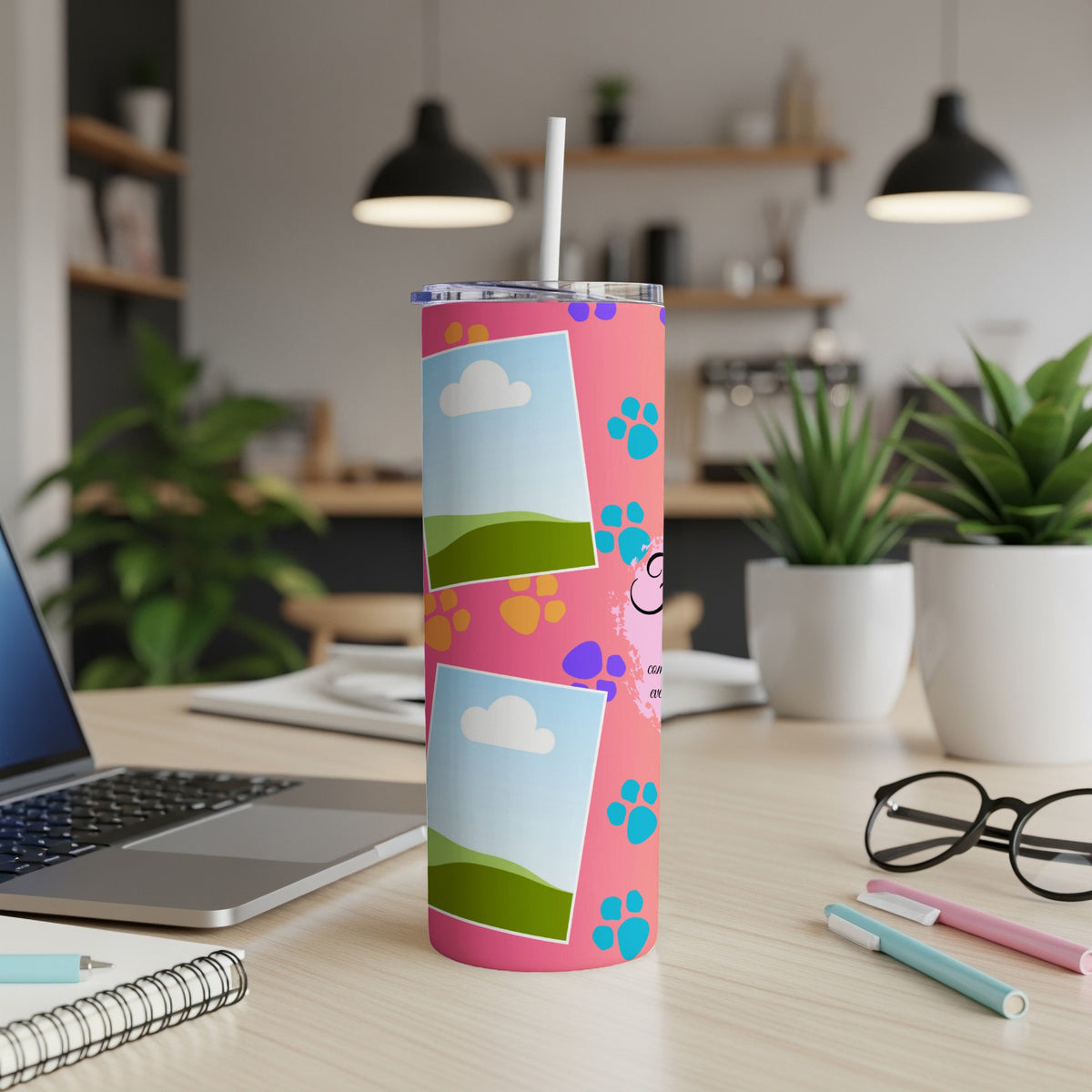 Pink tumbler with paw prints and photo frames, featuring a quote.