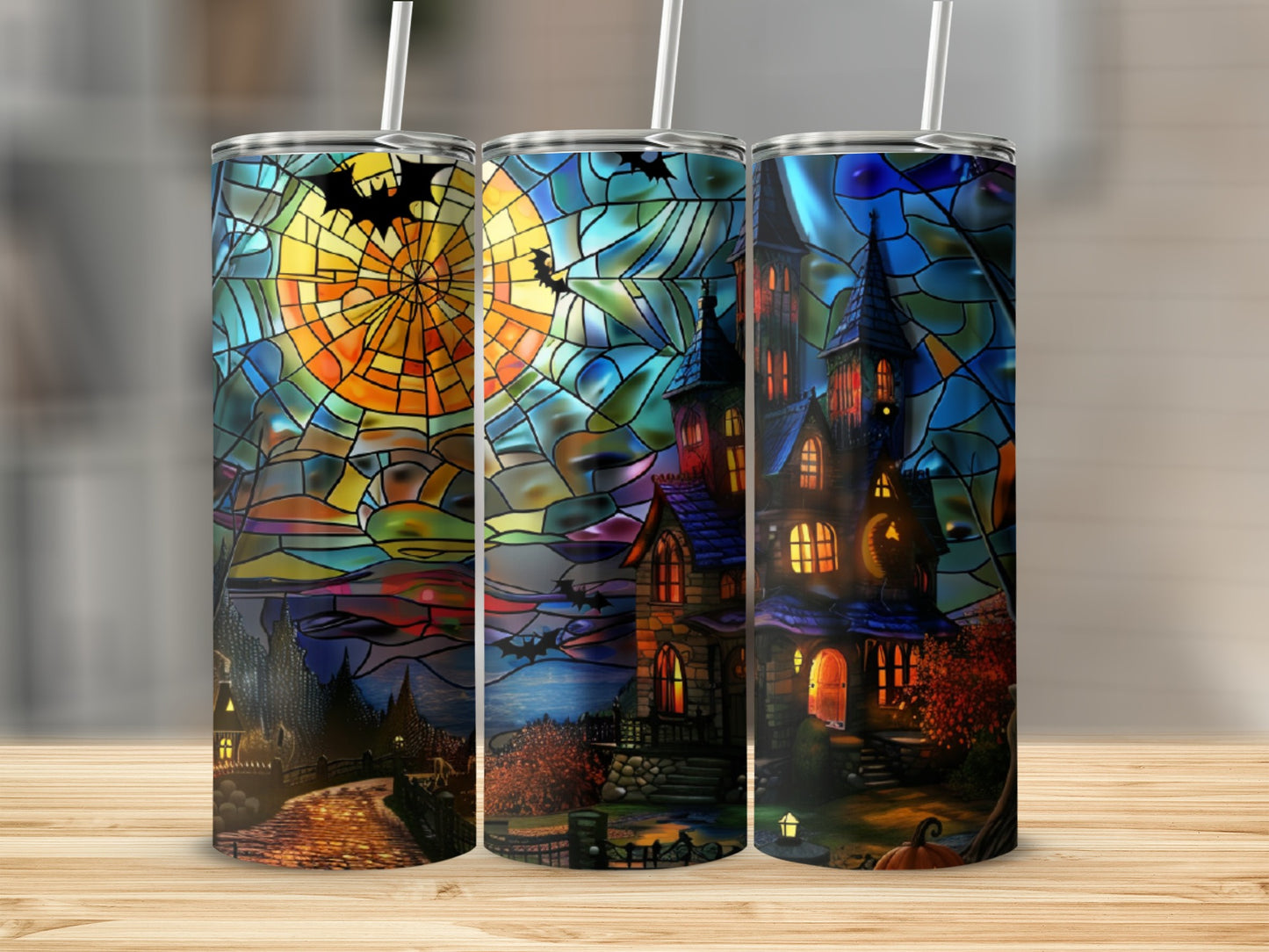 Stained glass tumbler with haunted house and moon Halloween scene.
